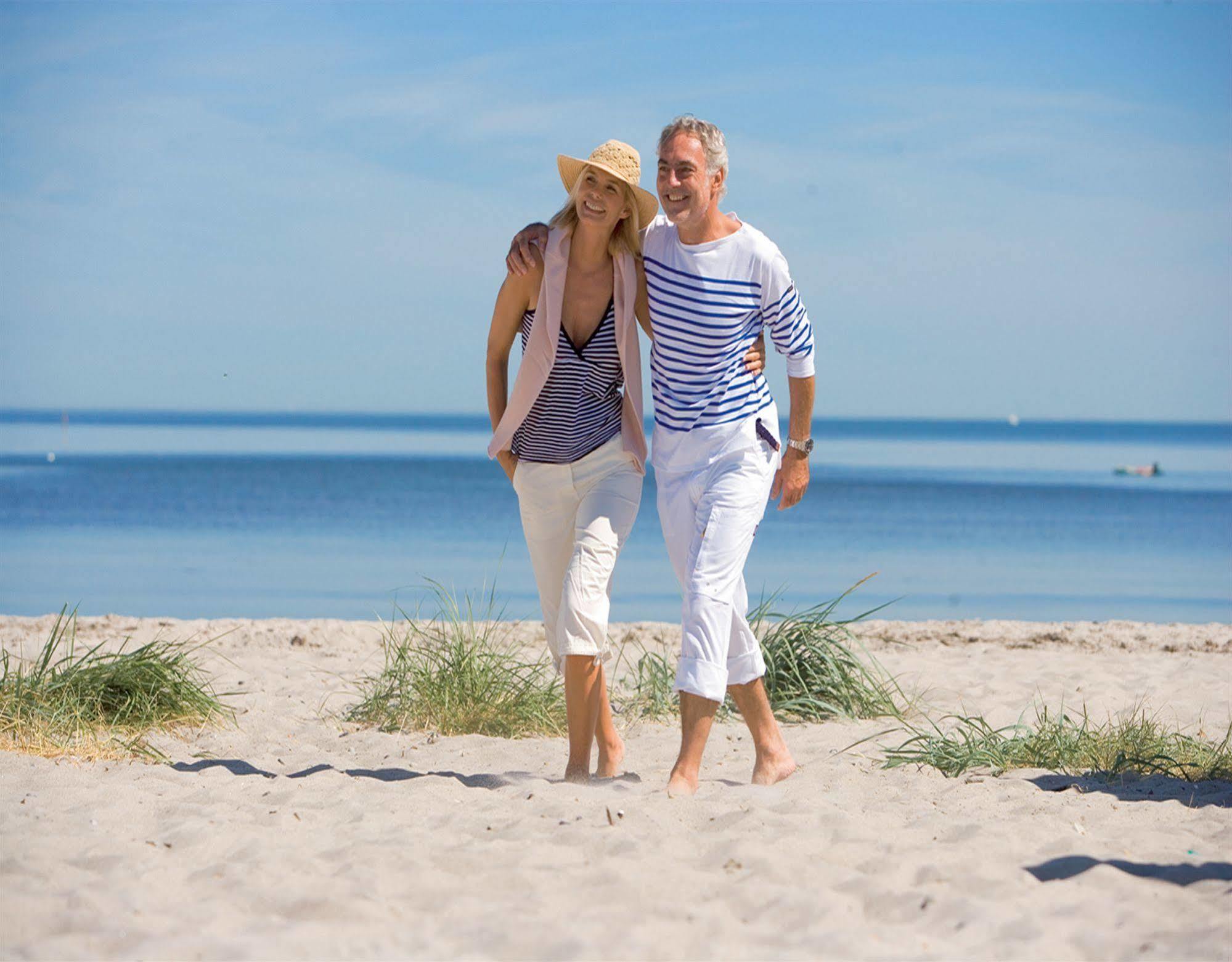 Hotel Yachthafenresidenz Hohe Duene Rostock Exteriér fotografie A couple walking on the beach